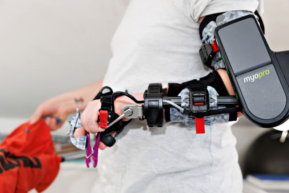 Ein Mann trägt eine MyoPro Armorthese.